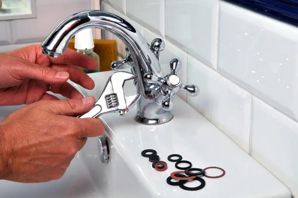 Plumber performing maintenance on a bathroom faucet in Colton