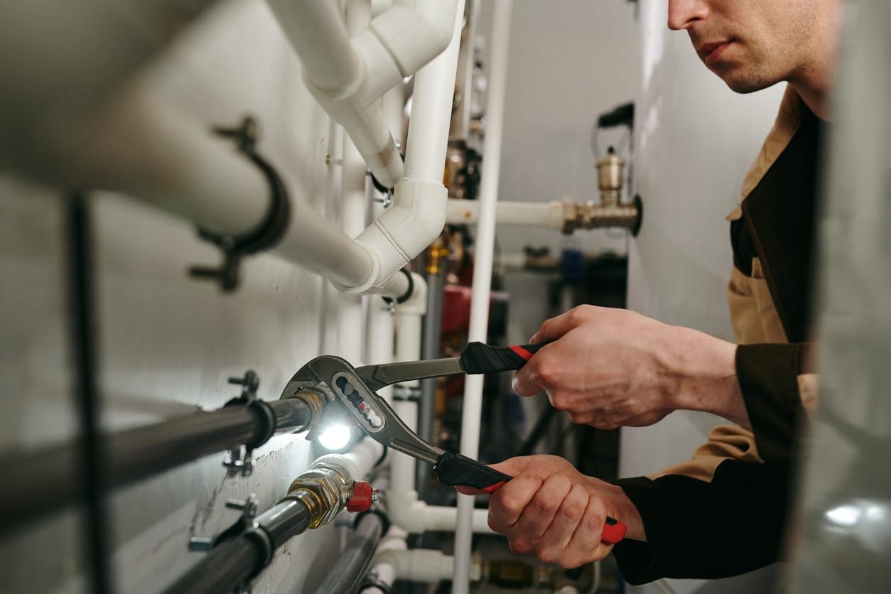 Plumbers maintaining commercial plumbing pipes in Colton
