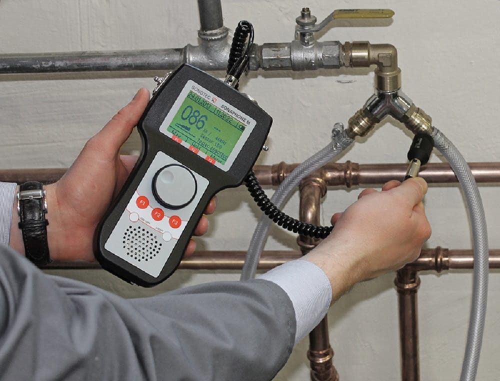 Plumber testing pipes with electronic leak detection equipment in Colton