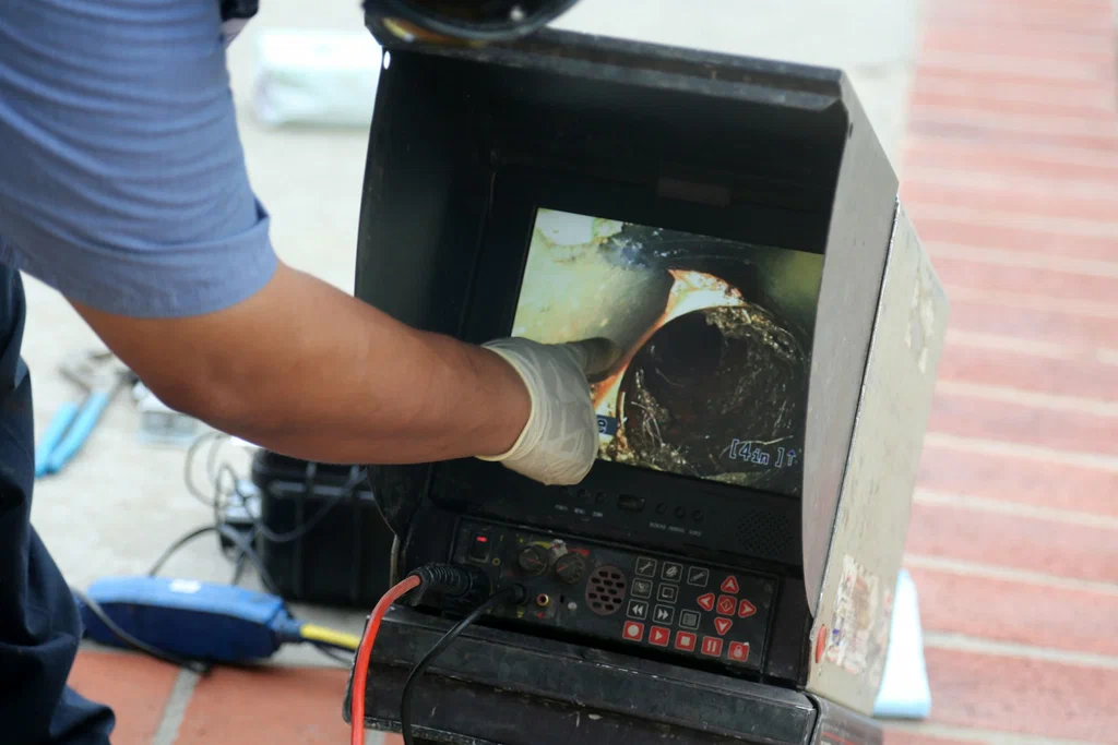 Technician viewing a drain inspection camera in Colton