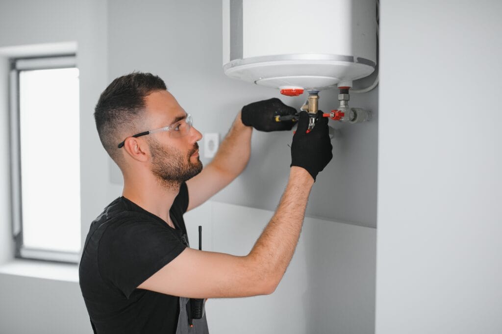 Technician performing water heater maintenance in Colton